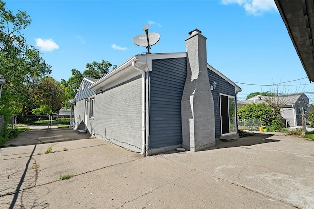 35519 Canyon Dr, Westland, MI 48186 - view of property exterior featuring a chimney and brick siding