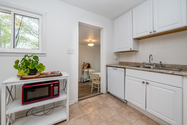 2630 Willa Dr, Saint Joseph, MI 49085 - kitchen with white appliances, a sink, tasteful backsplash, white cabinets, and light tile patterned floors