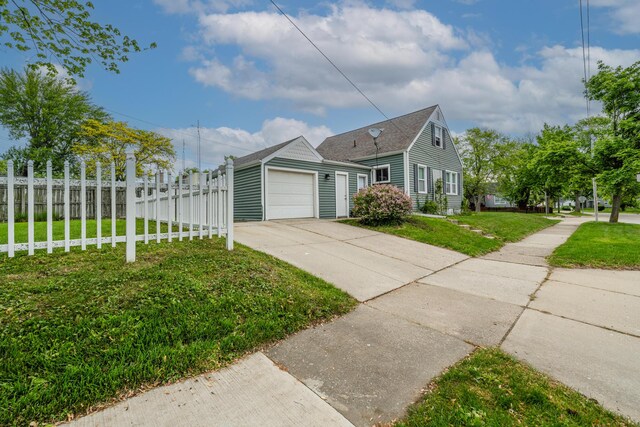 2630 Willa Dr, Saint Joseph, MI 49085 - view of property exterior with concrete driveway, an attached garage, and roof with shingles
