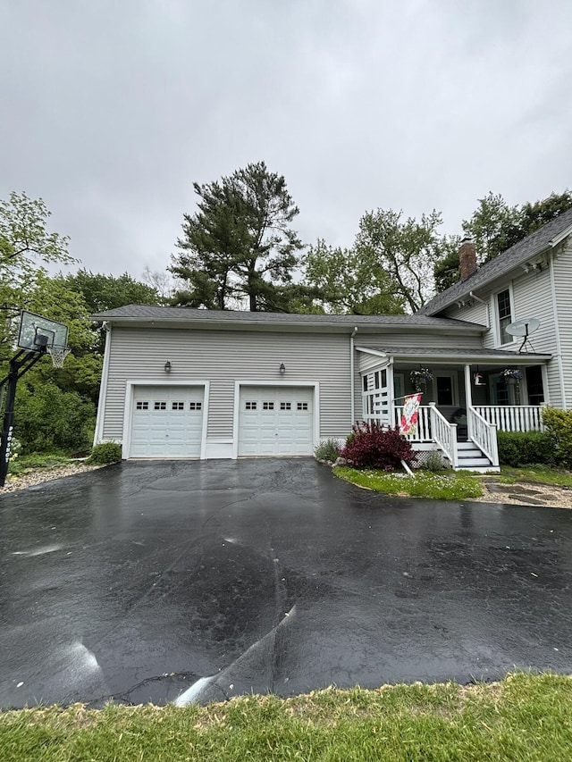 7100 Wing Lake Rd, Bloomfield Hills, MI 48301 - view of front of property with driveway, a porch, a chimney, and a garage