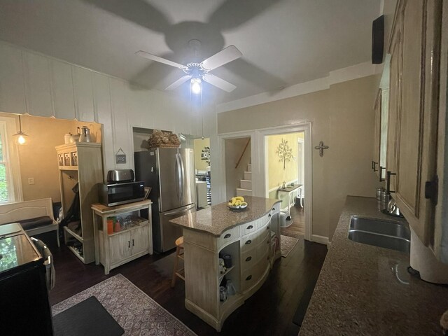 7100 Wing Lake Rd, Bloomfield Hills, MI 48301 - kitchen with stainless steel appliances, ceiling fan, dark wood-style flooring, a center island, and dark stone counters