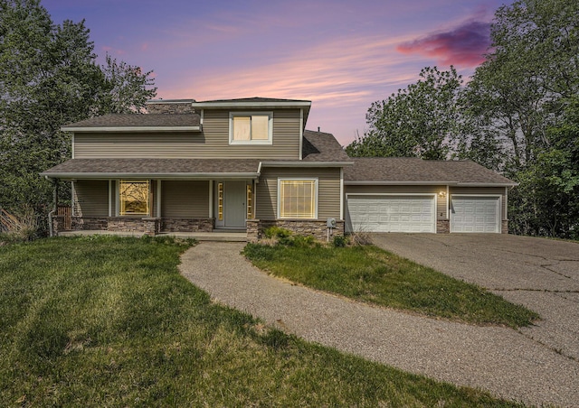 5643 Ivanrest Ave SW, Wyoming, MI 49418 - view of front of home with stone siding, asphalt driveway, an attached garage, and a lawn