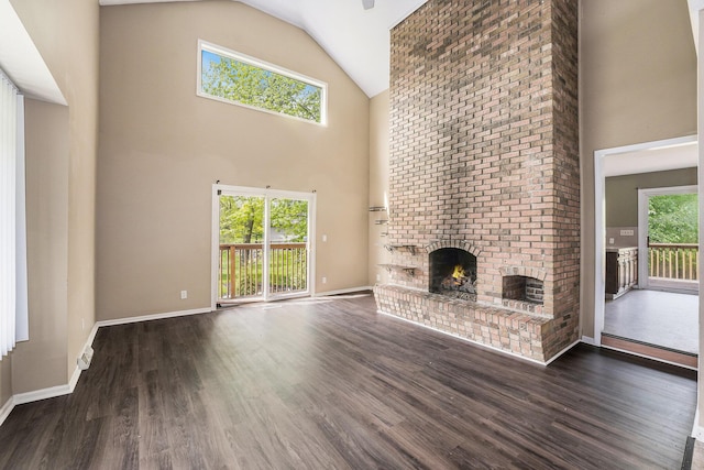 5643 Ivanrest Ave SW, Wyoming, MI 49418 - unfurnished living room with a fireplace, high vaulted ceiling, wood finished floors, and baseboards