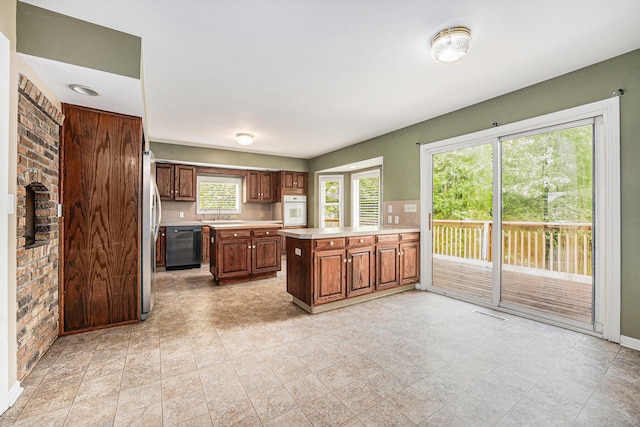 5643 Ivanrest Ave SW, Wyoming, MI 49418 - kitchen with white oven, light countertops, dishwasher, a peninsula, and a sink
