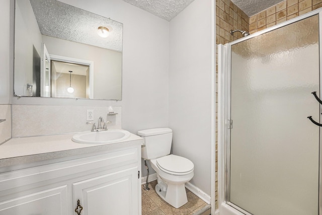 5643 Ivanrest Ave SW, Wyoming, MI 49418 - bathroom with a textured ceiling, a shower stall, vanity, toilet, and tile patterned flooring