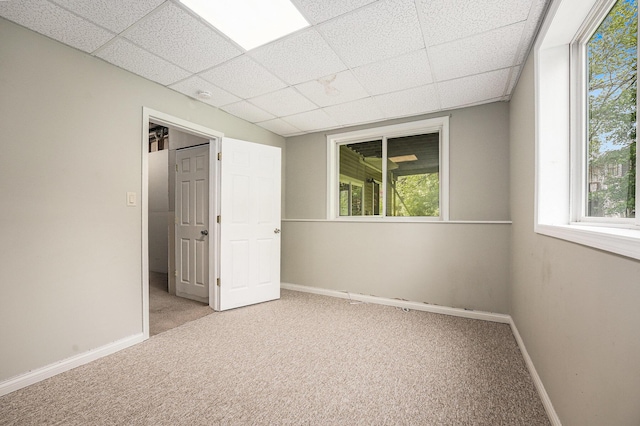 5643 Ivanrest Ave SW, Wyoming, MI 49418 - unfurnished bedroom with carpet flooring, baseboards, a paneled ceiling, and multiple windows