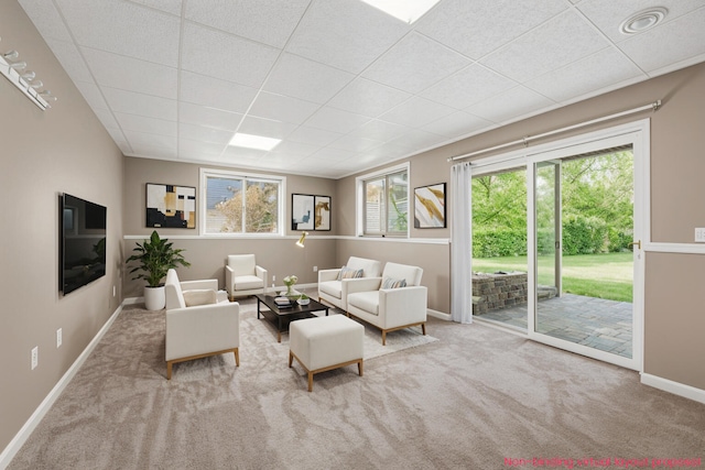 5643 Ivanrest Ave SW, Wyoming, MI 49418 - carpeted living area featuring a drop ceiling, baseboards, and plenty of natural light