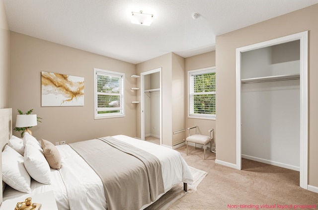 5643 Ivanrest Ave SW, Wyoming, MI 49418 - bedroom with multiple closets, light colored carpet, multiple windows, and baseboards