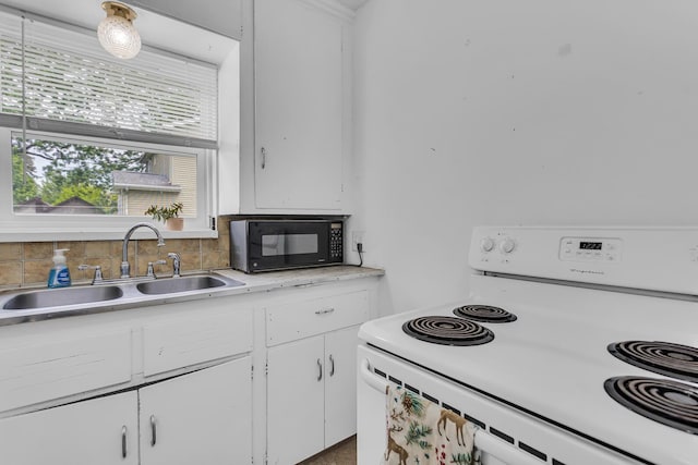 105 Renker Rd, Lansing, MI 48917 - kitchen featuring electric range, black microwave, a sink, light countertops, and white cabinetry