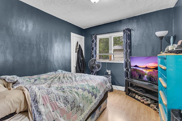 105 Renker Rd, Lansing, MI 48917 - bedroom with wood finished floors, a textured ceiling, and a textured wall