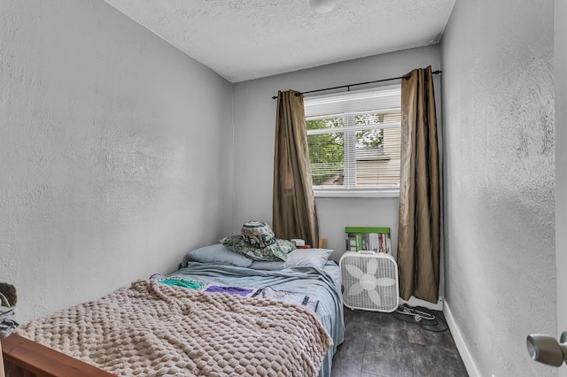 105 Renker Rd, Lansing, MI 48917 - bedroom featuring baseboards, a textured ceiling, a textured wall, and wood finished floors