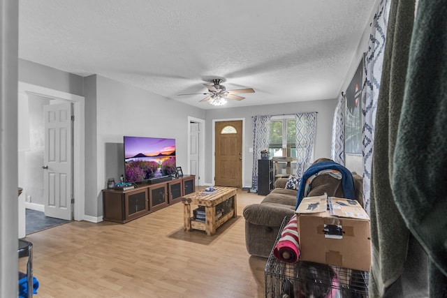 105 Renker Rd, Lansing, MI 48917 - living room with a ceiling fan, wood finished floors, a textured ceiling, and baseboards