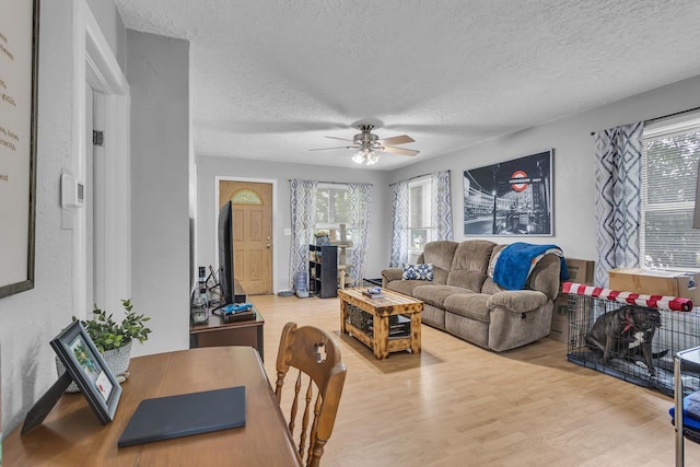 105 Renker Rd, Lansing, MI 48917 - living area with a textured ceiling, ceiling fan, and wood finished floors