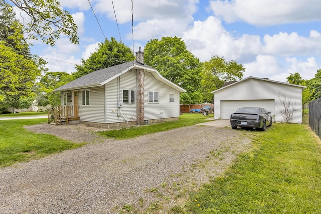 105 Renker Rd, Lansing, MI 48917 - view of home's exterior with a detached garage, an outdoor structure, a chimney, and roof with shingles