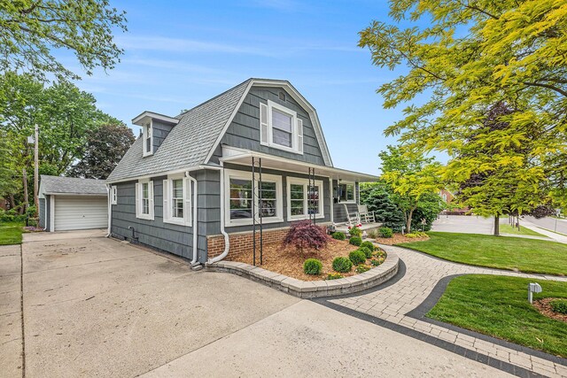 403 N Helen Ave, Rochester, MI 48307 - colonial inspired home featuring a front yard, a porch, an outbuilding, and a detached garage