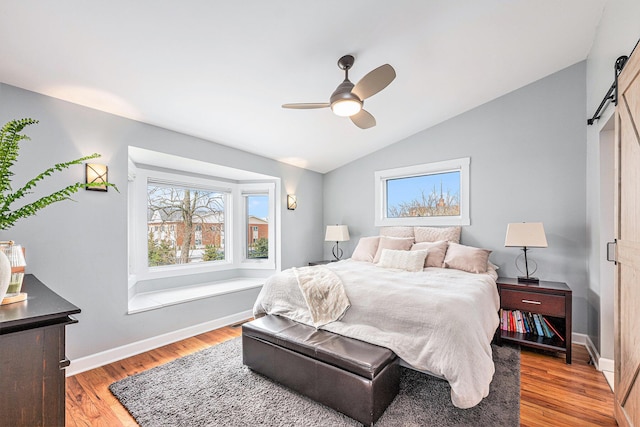 403 N Helen Ave, Rochester, MI 48307 - bedroom with a barn door, lofted ceiling, light wood-style flooring, baseboards, and ceiling fan