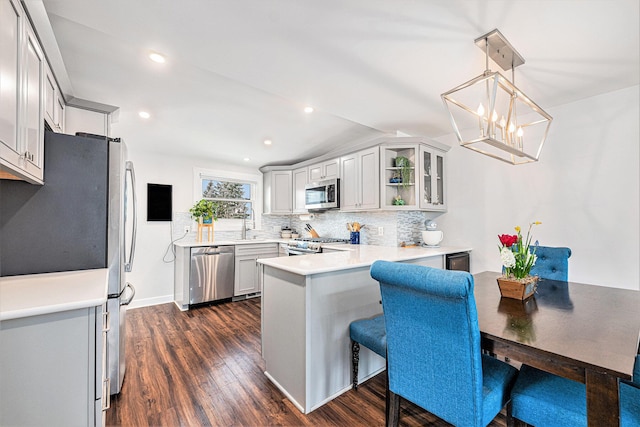403 N Helen Ave, Rochester, MI 48307 - kitchen with appliances with stainless steel finishes, a peninsula, backsplash, dark wood finished floors, and light countertops