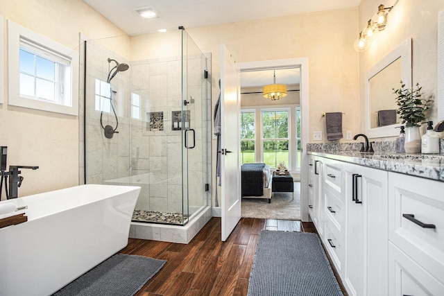 18919 I Dr N, Marshall, MI 49068 - bathroom with a soaking tub, a shower stall, vanity, wood finished floors, and connected bathroom
