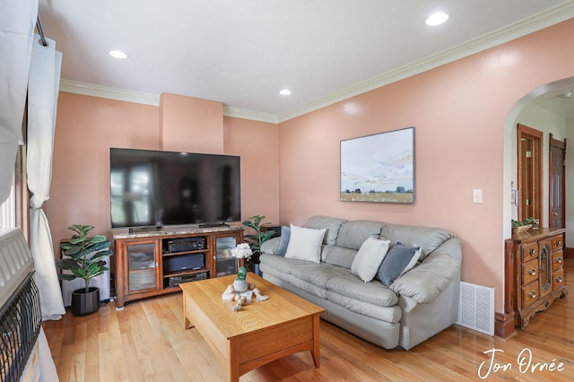 10551 James St, Zeeland, MI 49464 - living room featuring arched walkways, light wood-style flooring, ornamental molding, and recessed lighting