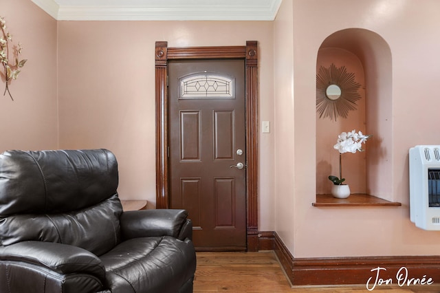 10551 James St, Zeeland, MI 49464 - entryway with heating unit, wood finished floors, ornamental molding, and baseboards