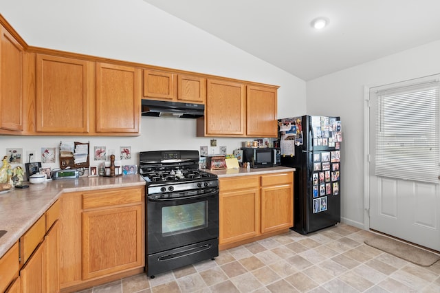 8761 Aveling Way, Richland, MI 49083 - kitchen with black appliances, under cabinet range hood, vaulted ceiling, and light countertops