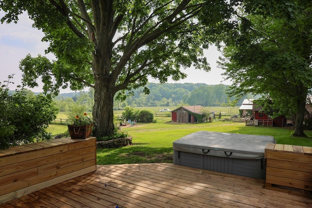 1041 W Arthur Rd, Rothbury, MI 49452 - wooden deck with a hot tub, a yard, and an outdoor structure