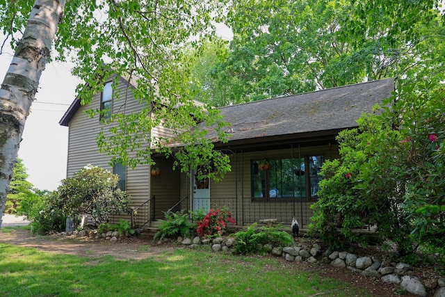 1041 W Arthur Rd, Rothbury, MI 49452 - view of front of house featuring covered porch and a front lawn