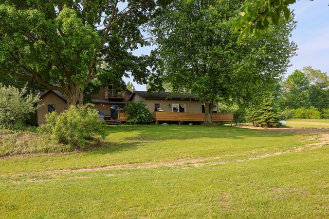 1041 W Arthur Rd, Rothbury, MI 49452 - view of green lawn with a wooden deck