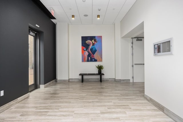 144 Oakes St SW Unit 1903, Grand Rapids, MI 49503 - corridor featuring a drop ceiling, light wood finished floors, and baseboards