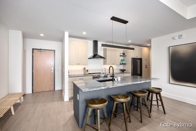 144 Oakes St SW Unit 1903, Grand Rapids, MI 49503 - kitchen with wall chimney range hood, black refrigerator, a sink, light wood finished floors, and recessed lighting