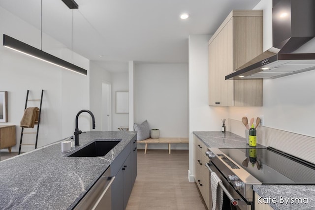 144 Oakes St SW Unit 1903, Grand Rapids, MI 49503 - kitchen with wall chimney range hood, range with electric cooktop, a sink, dark stone countertops, and light wood finished floors