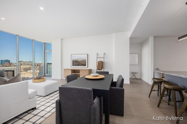 144 Oakes St SW Unit 1903, Grand Rapids, MI 49503 - dining area featuring light wood-style floors, expansive windows, baseboards, recessed lighting, and a city view