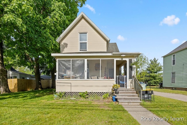 717 Pleasant St, Belding, MI 48809 - view of front of home featuring a sunroom