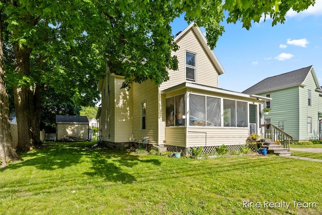 717 Pleasant St, Belding, MI 48809 - view of front of home with a sunroom and a front lawn