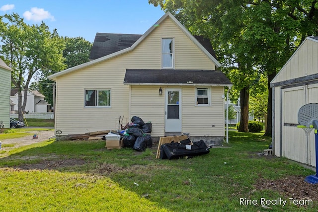 717 Pleasant St, Belding, MI 48809 - back of house with a yard, roof with shingles, and entry steps
