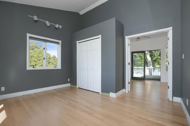 70847 Claire Dr, Union, MI 49130 - unfurnished bedroom featuring multiple windows, light wood-style floors, and baseboards