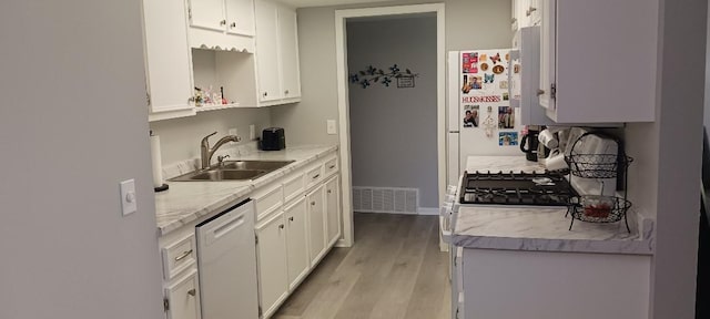 5230 Southbrook Ct Unit 78, Hudsonville, MI 49426 - kitchen with a sink, white dishwasher, light wood-style floors, and light countertops