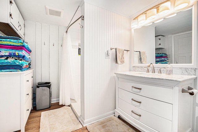 17437 Lakeview Dr Unit 100, Vandalia, MI 49095 - bathroom featuring vanity, wood finished floors, and curtained shower