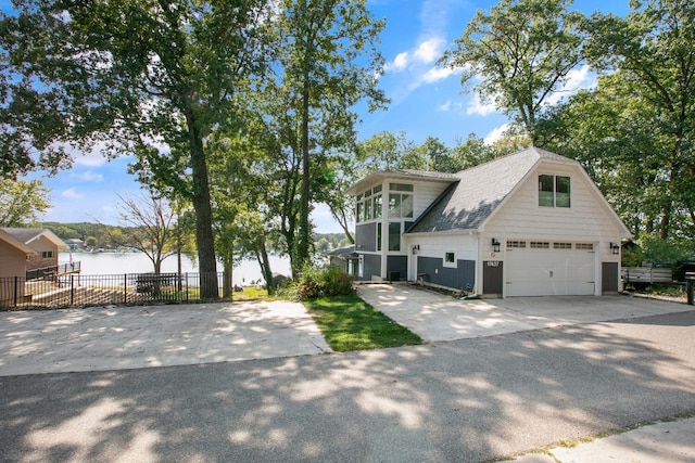 17437 Lakeview Dr Unit 100, Vandalia, MI 49095 - view of front facade featuring a water view, driveway, and a shingled roof