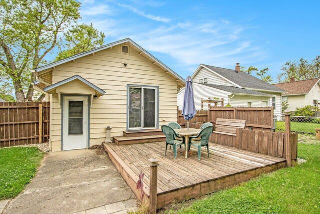 208 Nelson Ave, Kalamazoo, MI 49006 - back of house with a wooden deck, a fenced backyard, and outdoor dining area