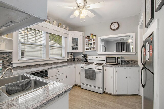 208 Nelson Ave, Kalamazoo, MI 49006 - kitchen featuring appliances with stainless steel finishes, a ceiling fan, a sink, and white cabinetry