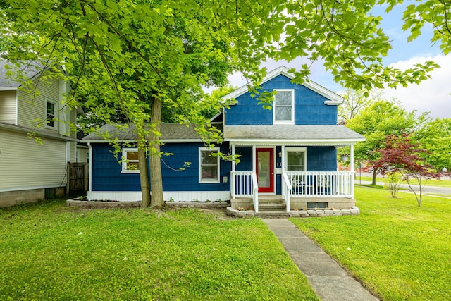 115 Mckinley St, Chelsea, MI 48118 - view of front of property with a porch, a front yard, and a shingled roof