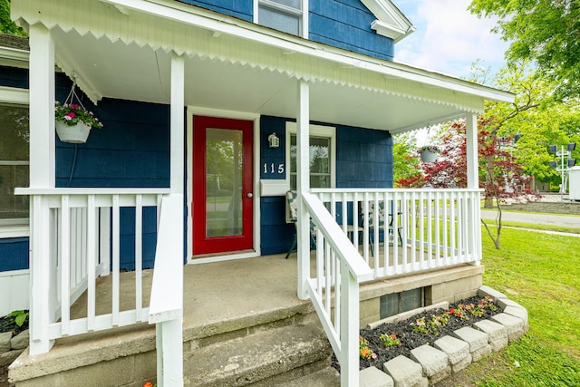 115 Mckinley St, Chelsea, MI 48118 - property entrance featuring covered porch and a lawn