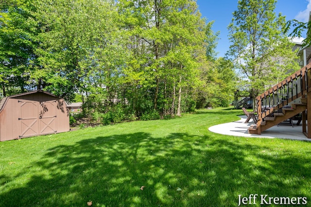 7153 Keystone Ct, Jenison, MI 49428 - view of grassy yard featuring stairway, a patio, and view of scattered trees