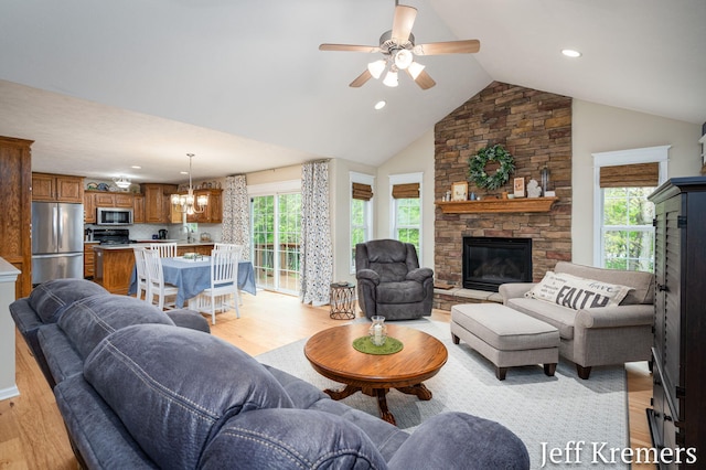 7153 Keystone Ct, Jenison, MI 49428 - living area with a fireplace, light wood finished floors, ceiling fan, lofted ceiling, and recessed lighting