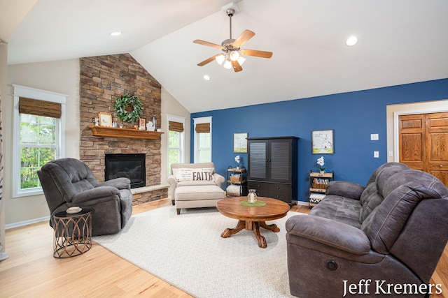 7153 Keystone Ct, Jenison, MI 49428 - living area featuring wood finished floors, plenty of natural light, ceiling fan, a fireplace, and high vaulted ceiling