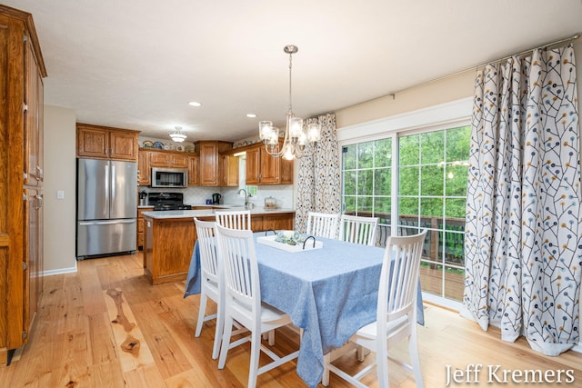 7153 Keystone Ct, Jenison, MI 49428 - dining area with a chandelier, light wood-style flooring, and recessed lighting