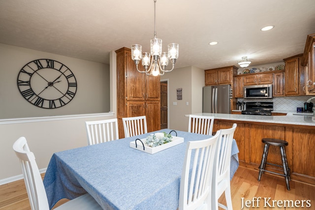 7153 Keystone Ct, Jenison, MI 49428 - dining space with light wood-style flooring, a chandelier, recessed lighting, and baseboards