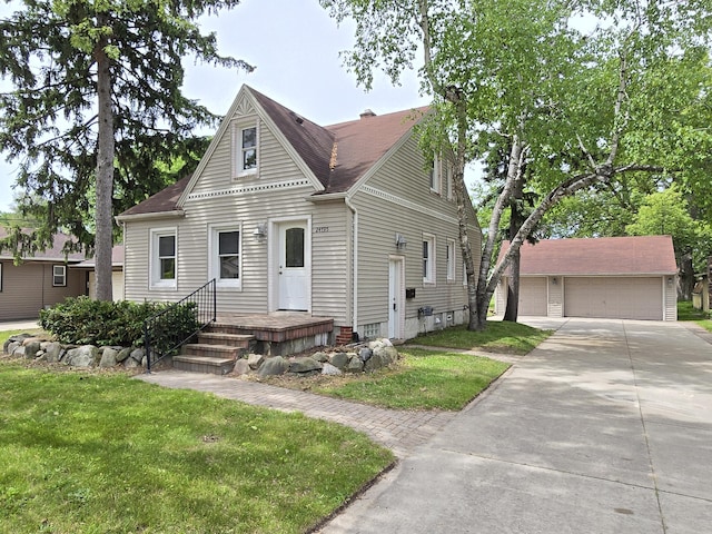 24795 Eureka Ave, Warren, MI 48091 - view of front facade with a front yard, an outbuilding, and a detached garage