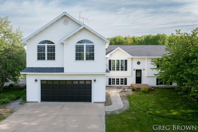 9318 Jefferson Rd, Lakeview, MI 48850 - bi-level home featuring an attached garage, concrete driveway, a front lawn, and a shingled roof